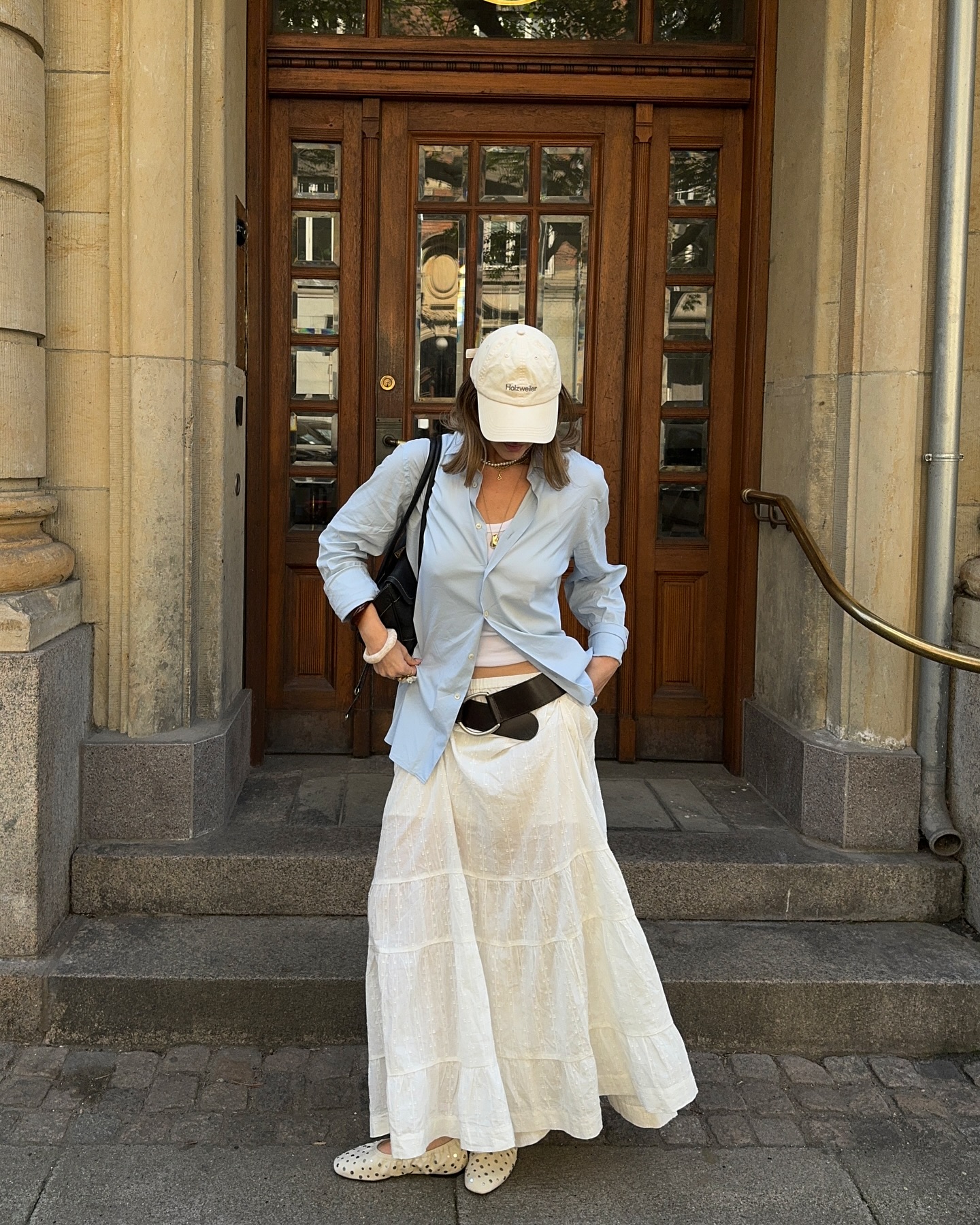 Oversized blue button-down shirt with a white tiered maxi skirt