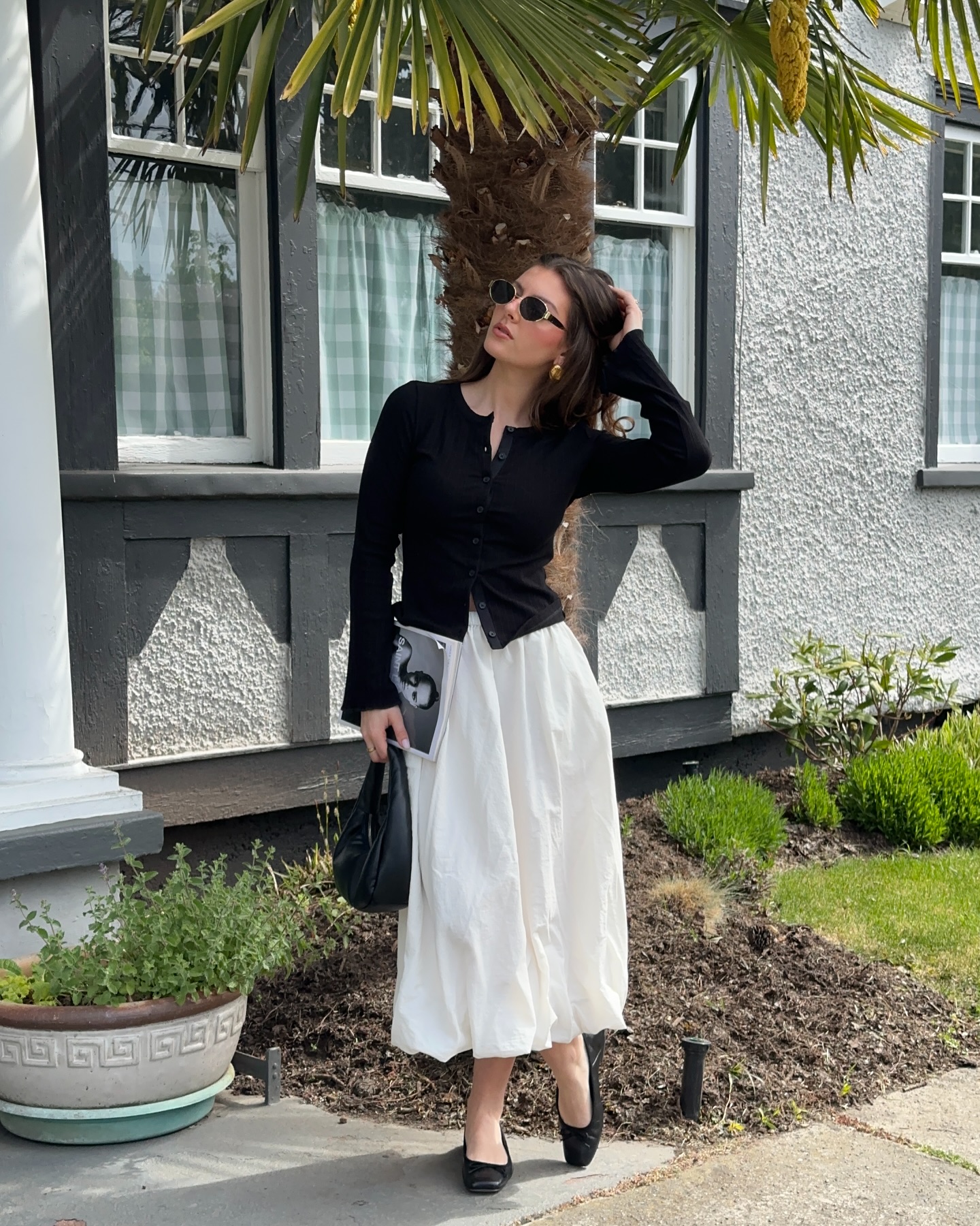 Black cardigan with a white full midi skirt