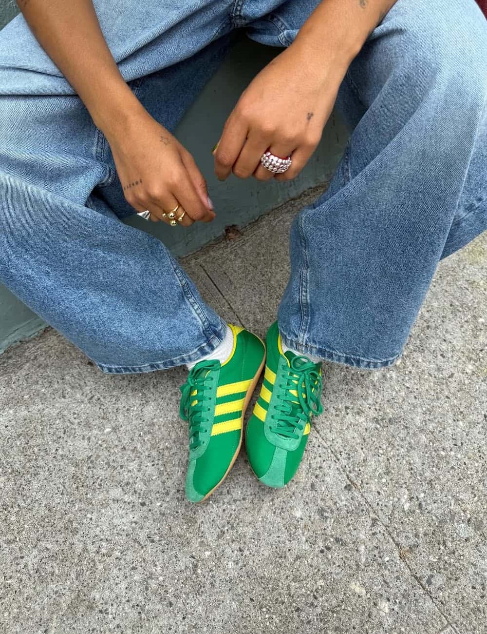 Woman wearing vibrant green and yellow sneakers