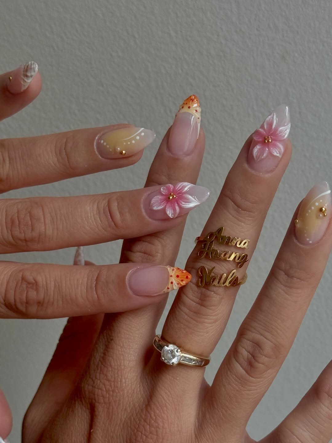 Soft pink nails with 3D floral accents