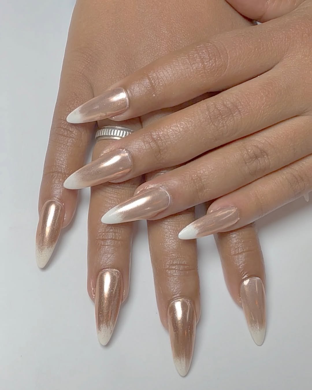 Champagne chrome nails with a soft white ombré effect