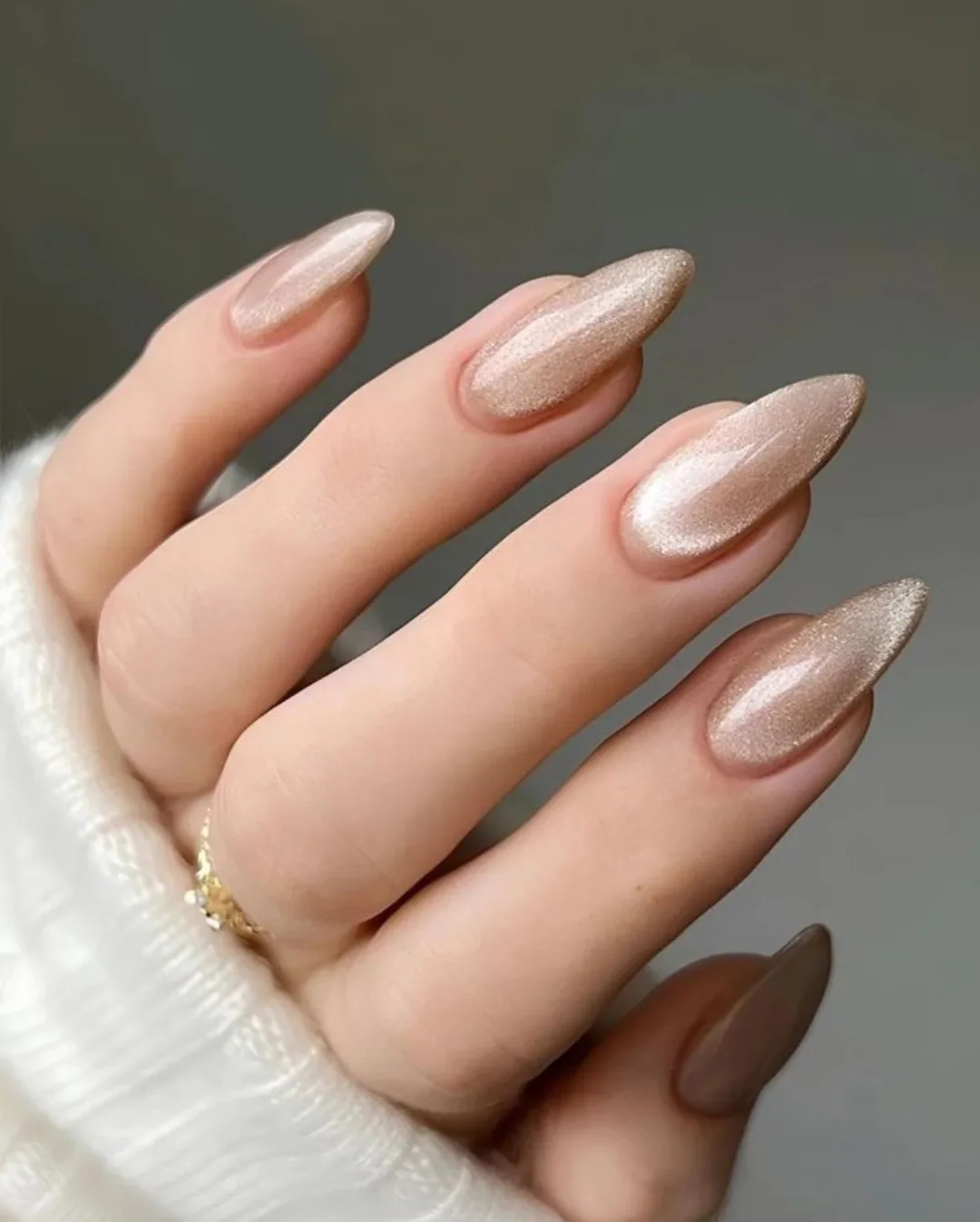 Almond-shaped nails with a champagne shimmer finish
