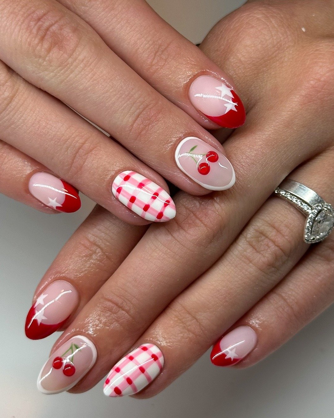 Red French tips with cherry motifs and gingham pattern