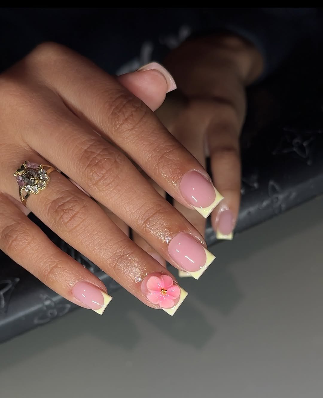 Soft nude nails with a single floral accent nail