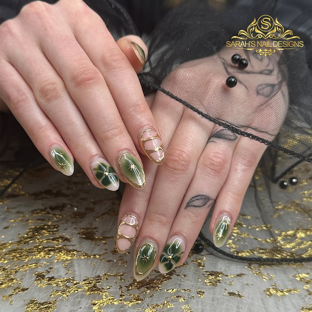Deep olive nails with gold outlines and abstract details