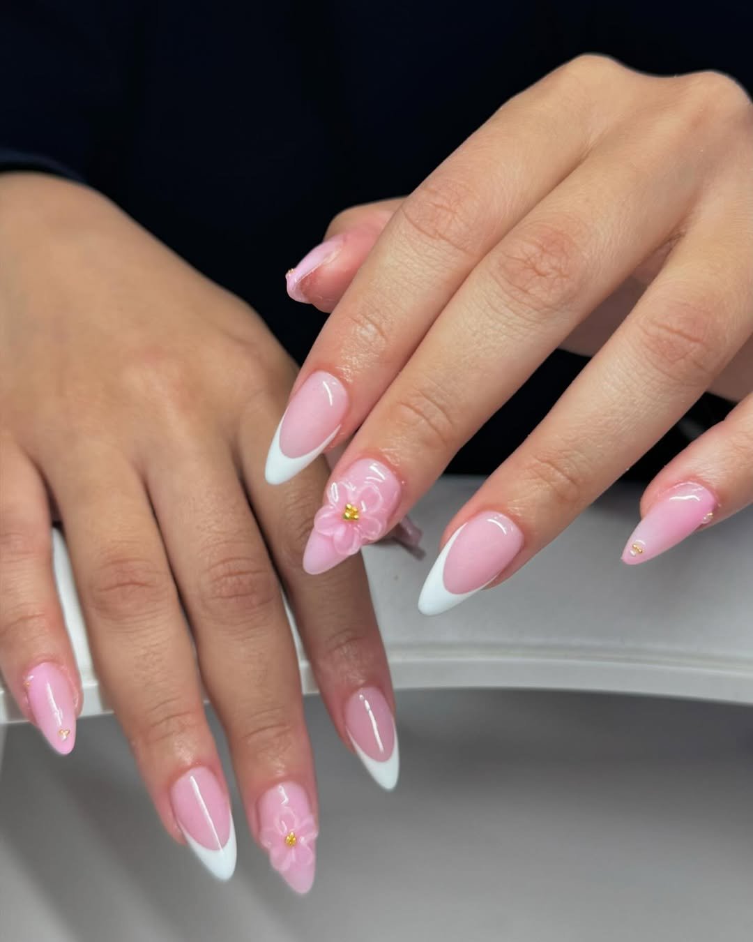 Baby pink French tips with a 3D flower accent