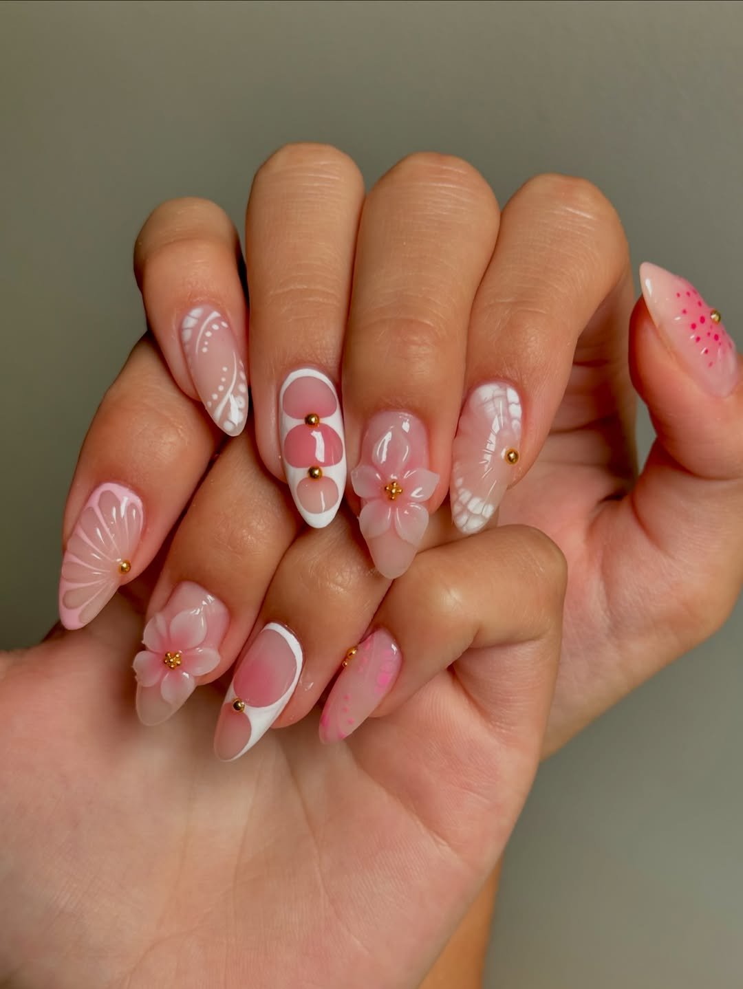 Sheer pink nails with delicate white floral accents
