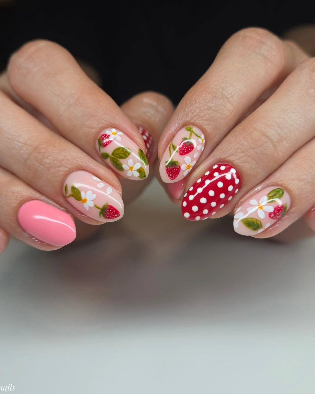 Nails with strawberries, daisies, and soft pink accents