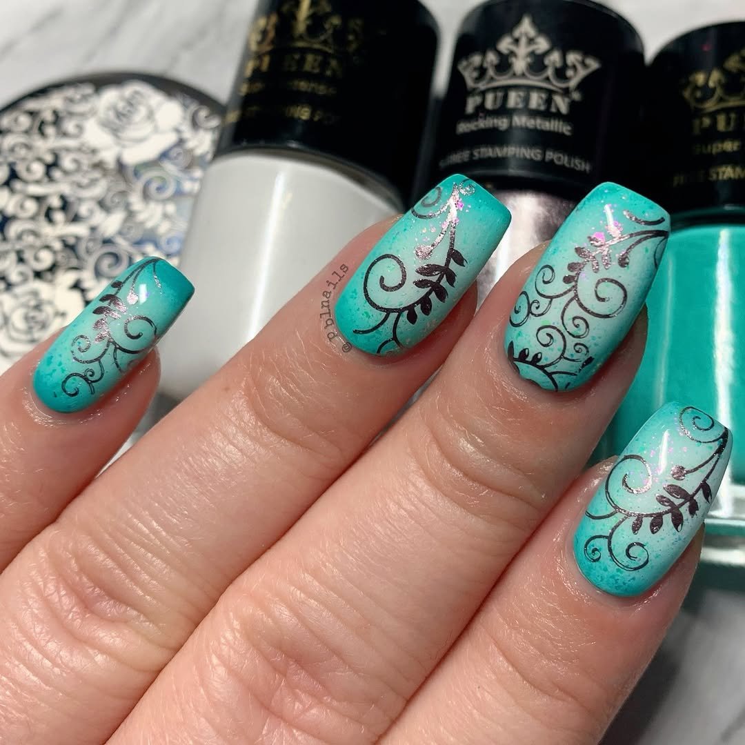 Teal nails with metallic black and silver scroll details